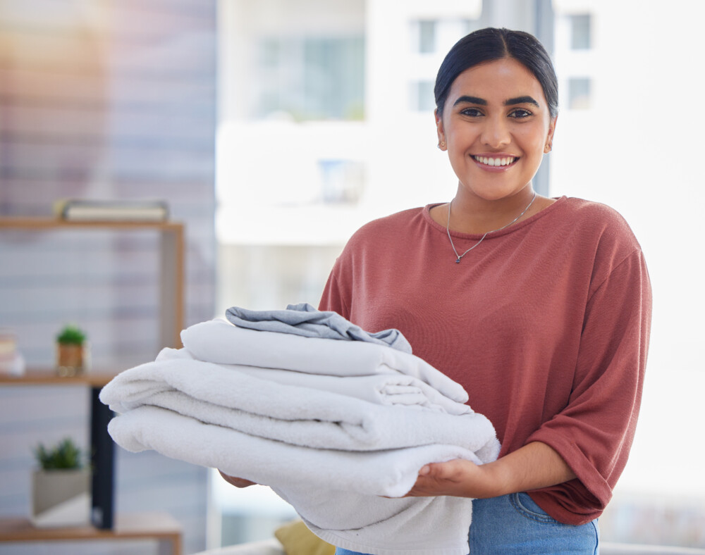 cleaning-laundry-and-portrait-of-woman-in-living-2025-04-06-12-44-10-utc